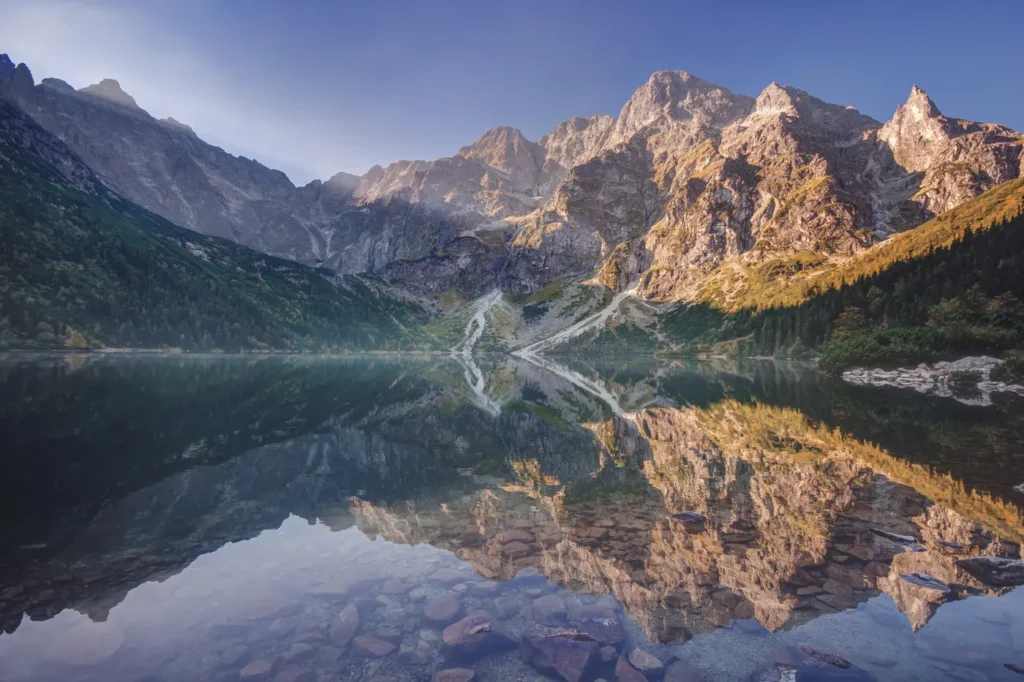 Najpiękniejsze miejsca w Polsce – Morskie Oko o poranku, w wodzie odbijają się Mięguszowieckie Szczyty